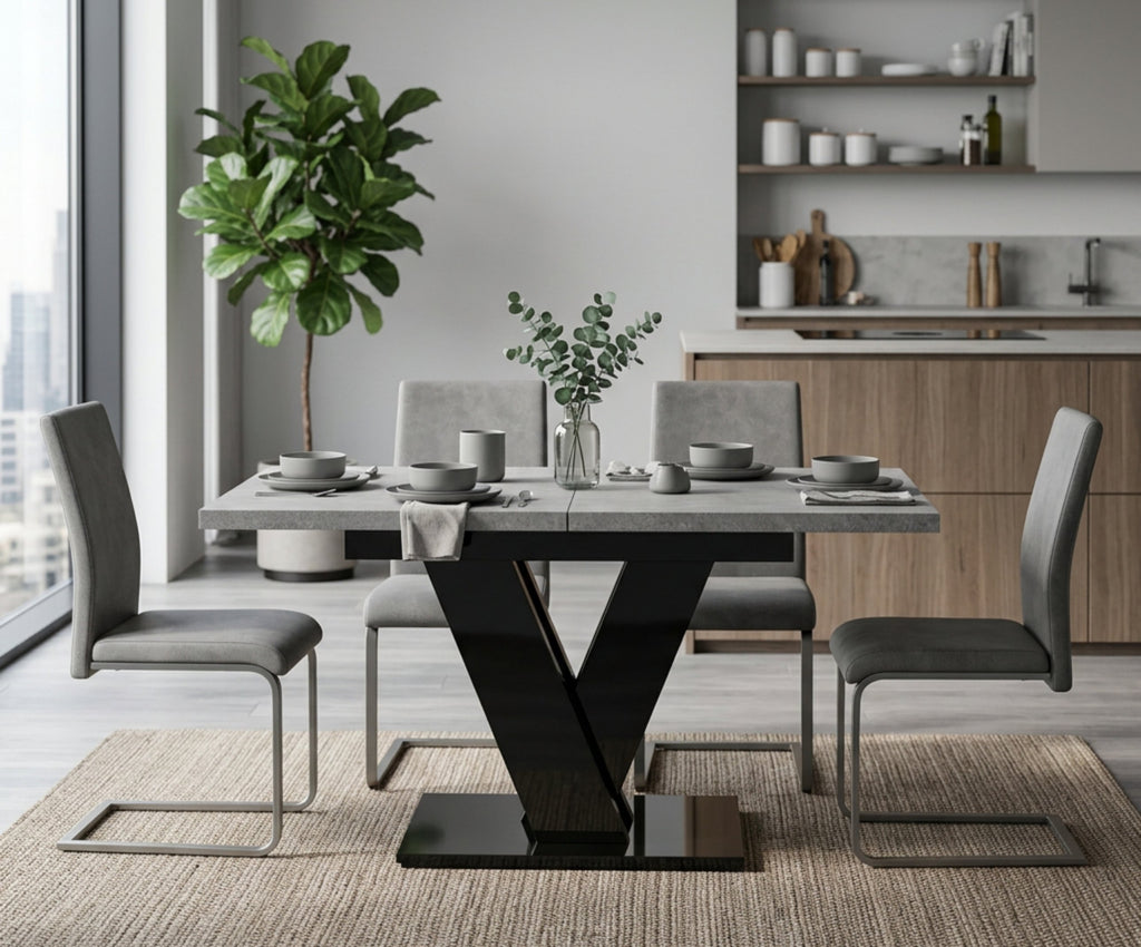 Grey concrete effect dining table with black gloss V base in a modern kitchen, set for four
