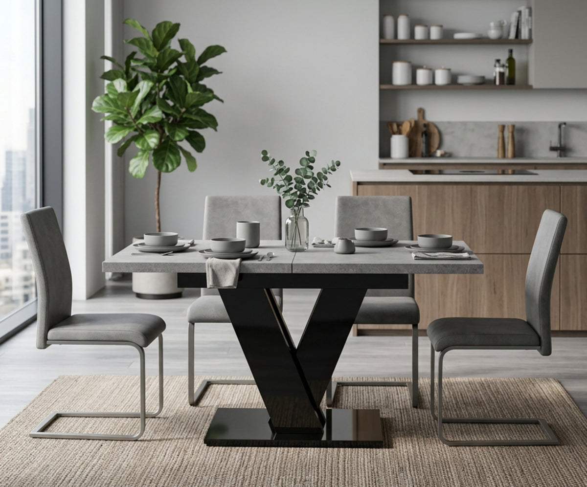 Grey concrete effect dining table with black gloss V base in a modern kitchen, set for four