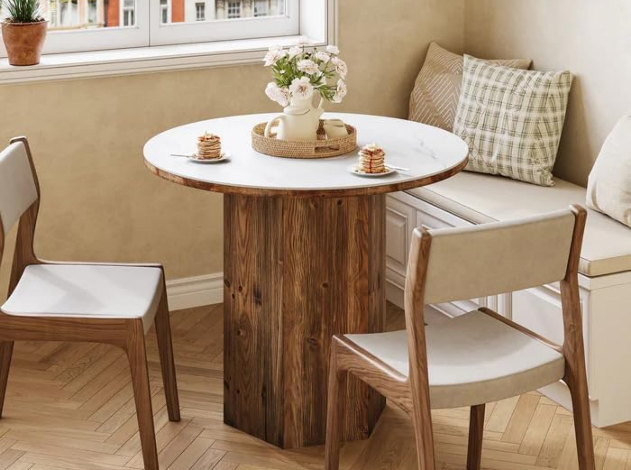 Small round kitchen table with sintered stone surface and wooden base, cozy dining area, minimalist bistro table design