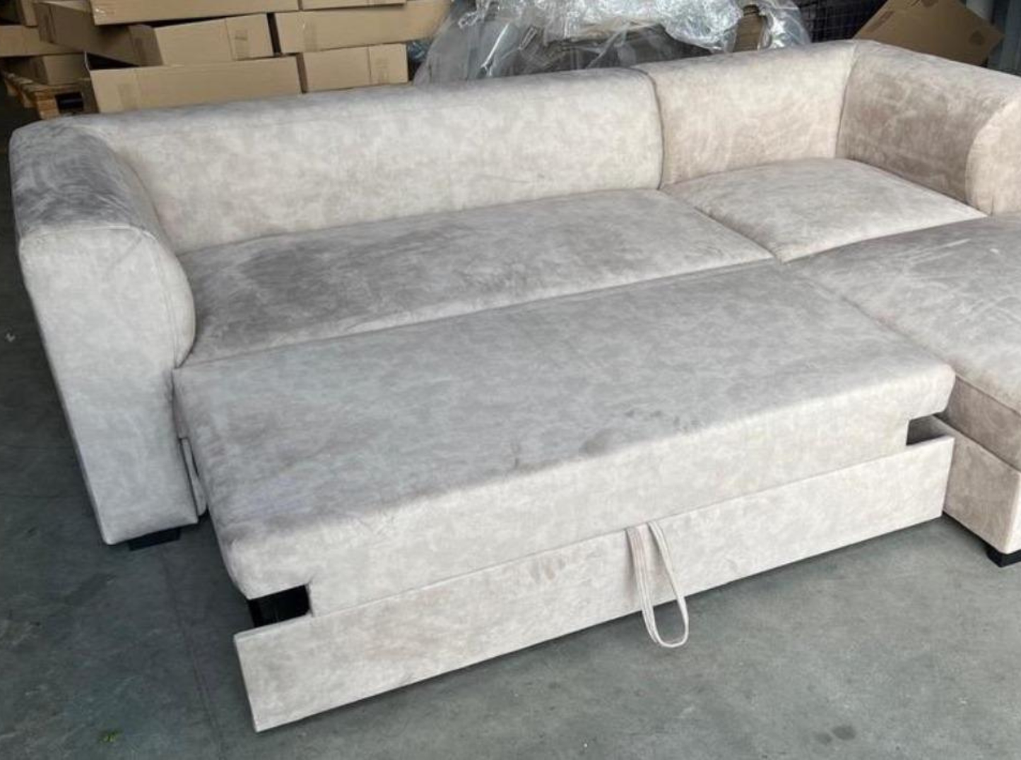 beige corner sofa bed styled in a bright contemporary living room, velvet upholstery, wooden legs