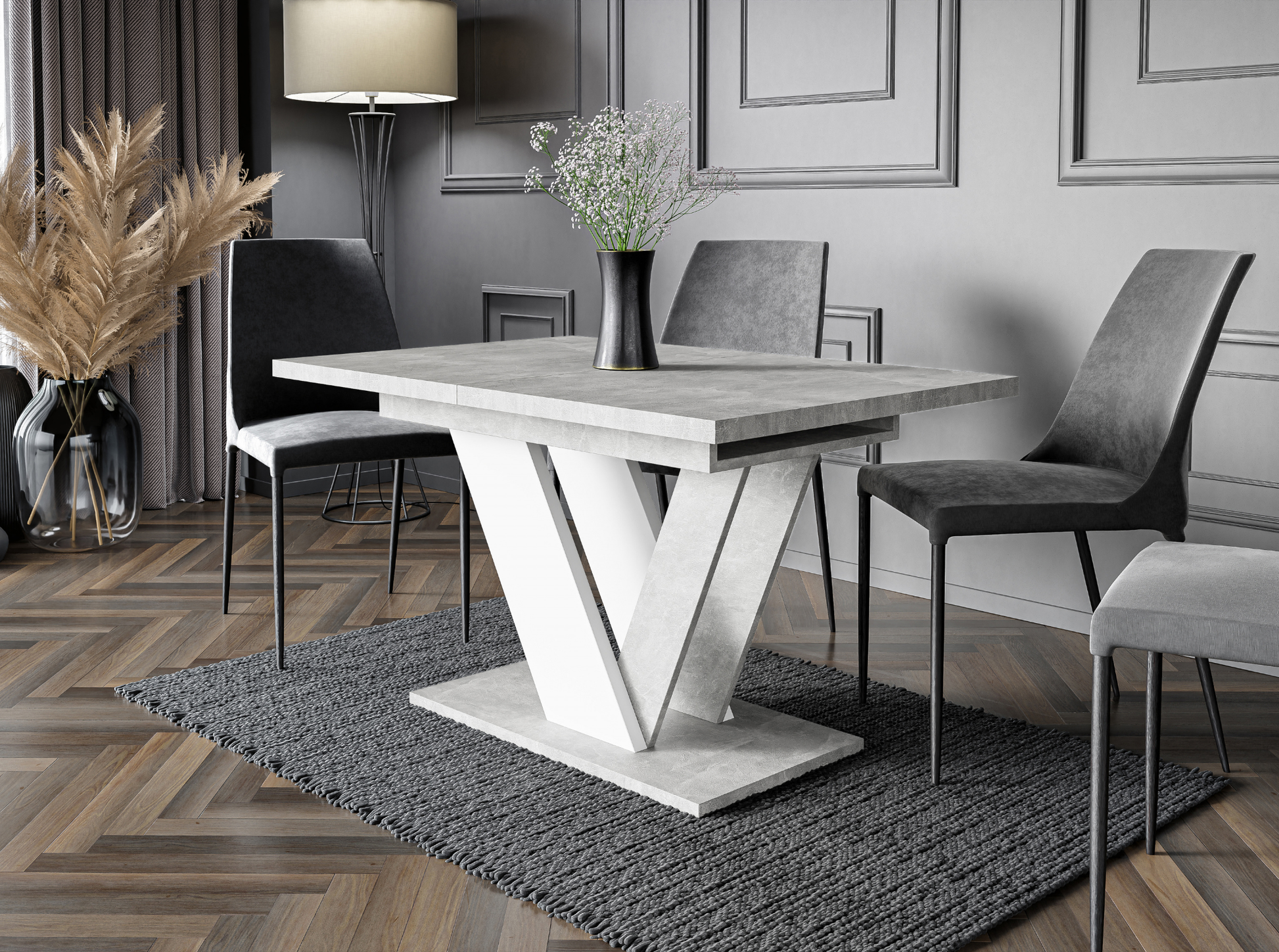Modern dining room with a concrete table and gray chairs on a patterned rug.