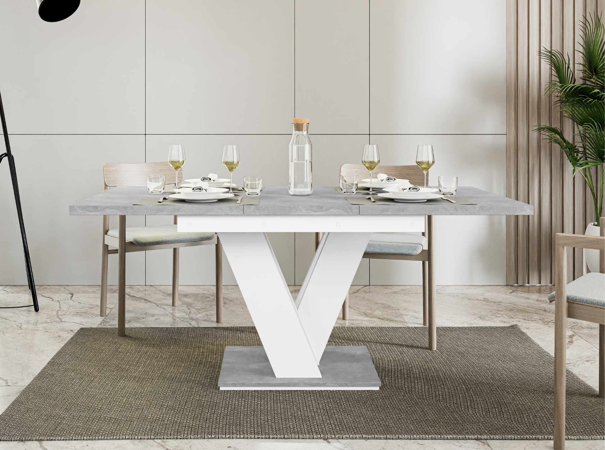 Compact extendable dining table with grey concrete top and white stand.