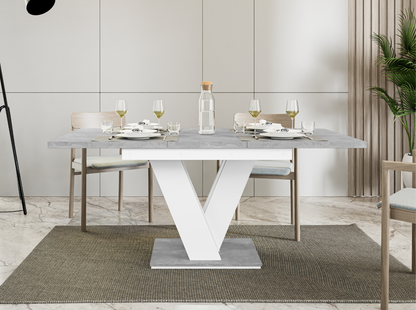 Compact extendable dining table with grey concrete top and white stand.