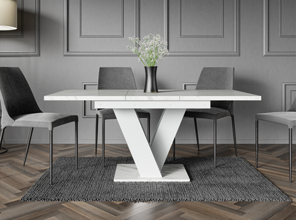 Glamour dining table with white marble top and matching white V-shaped stand.