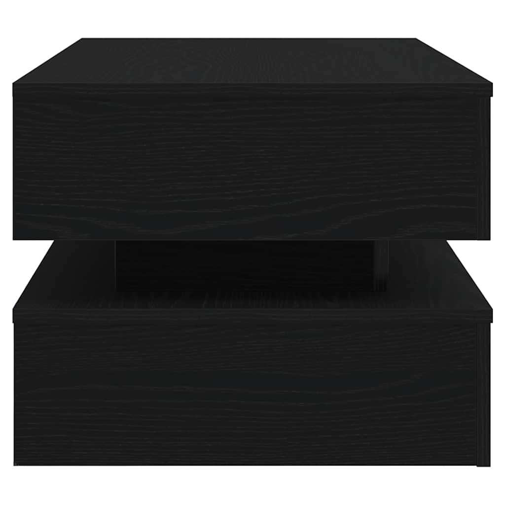 Small black side table with layered shelves and modern rectangular design, ideal beside a sofa.