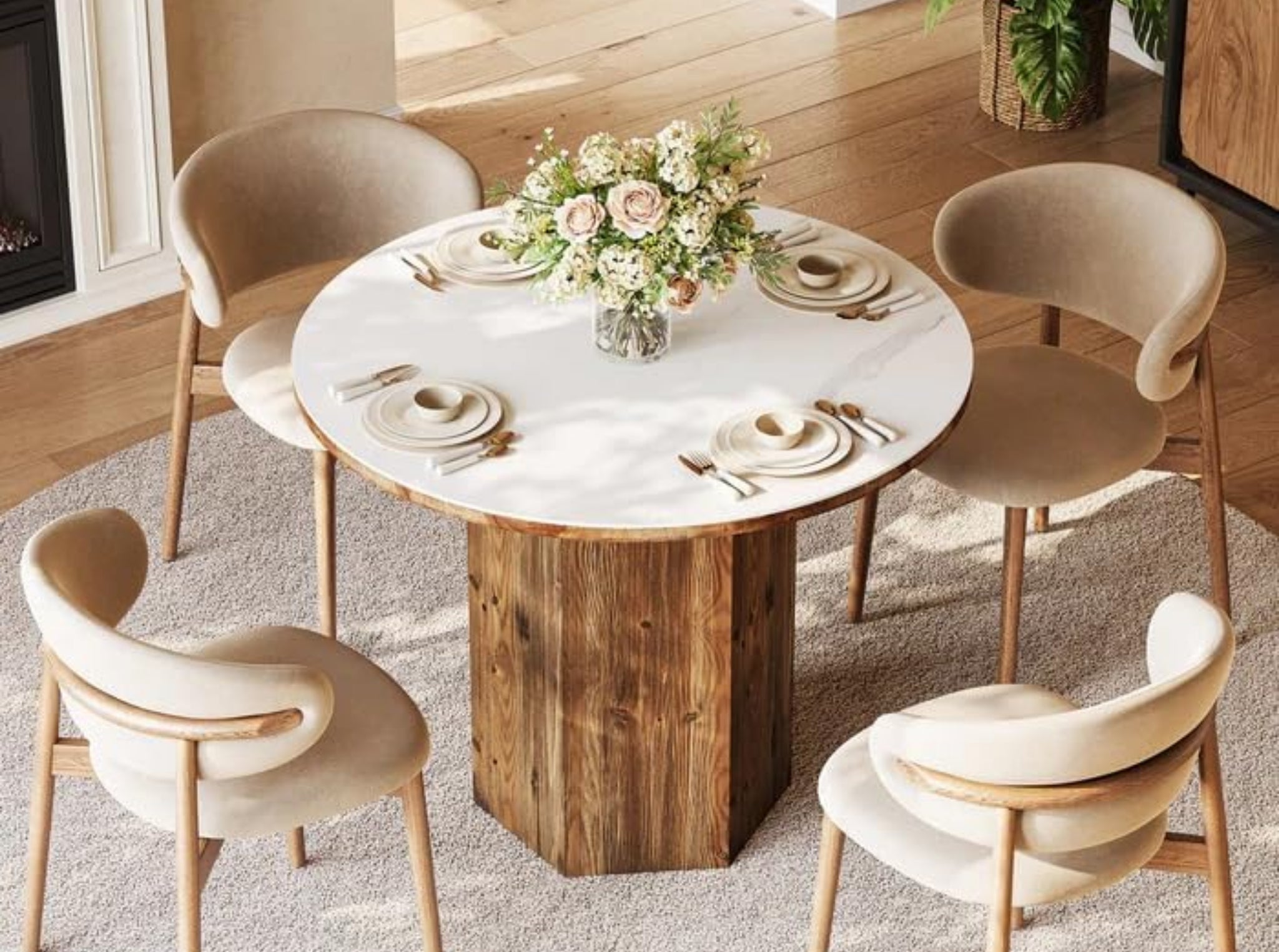 Round dining table with sintered stone top and solid wood base in bright interior, small kitchen table set with chairs, modern bistro style