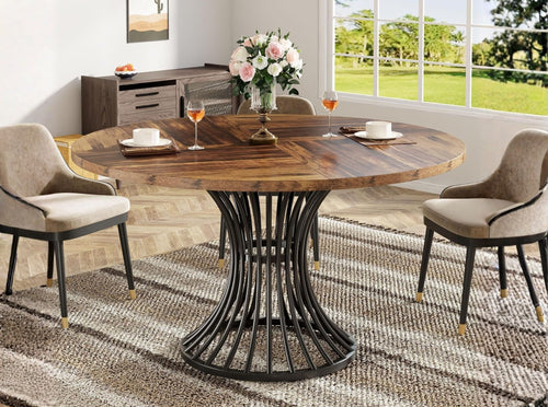 Round wooden bistro table with metal base in cozy interior, compact kitchen table with chairs, contemporary dining setup