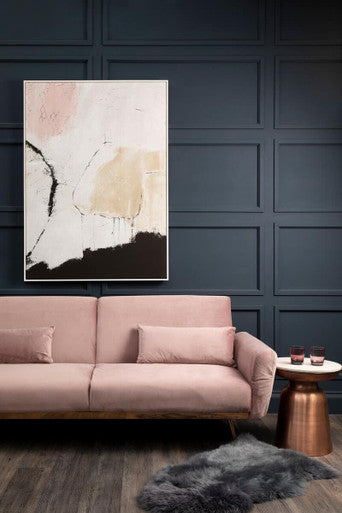 Elegant pink sofa bed styled against a dark blue wall, blending modern aesthetics with soft comfort.