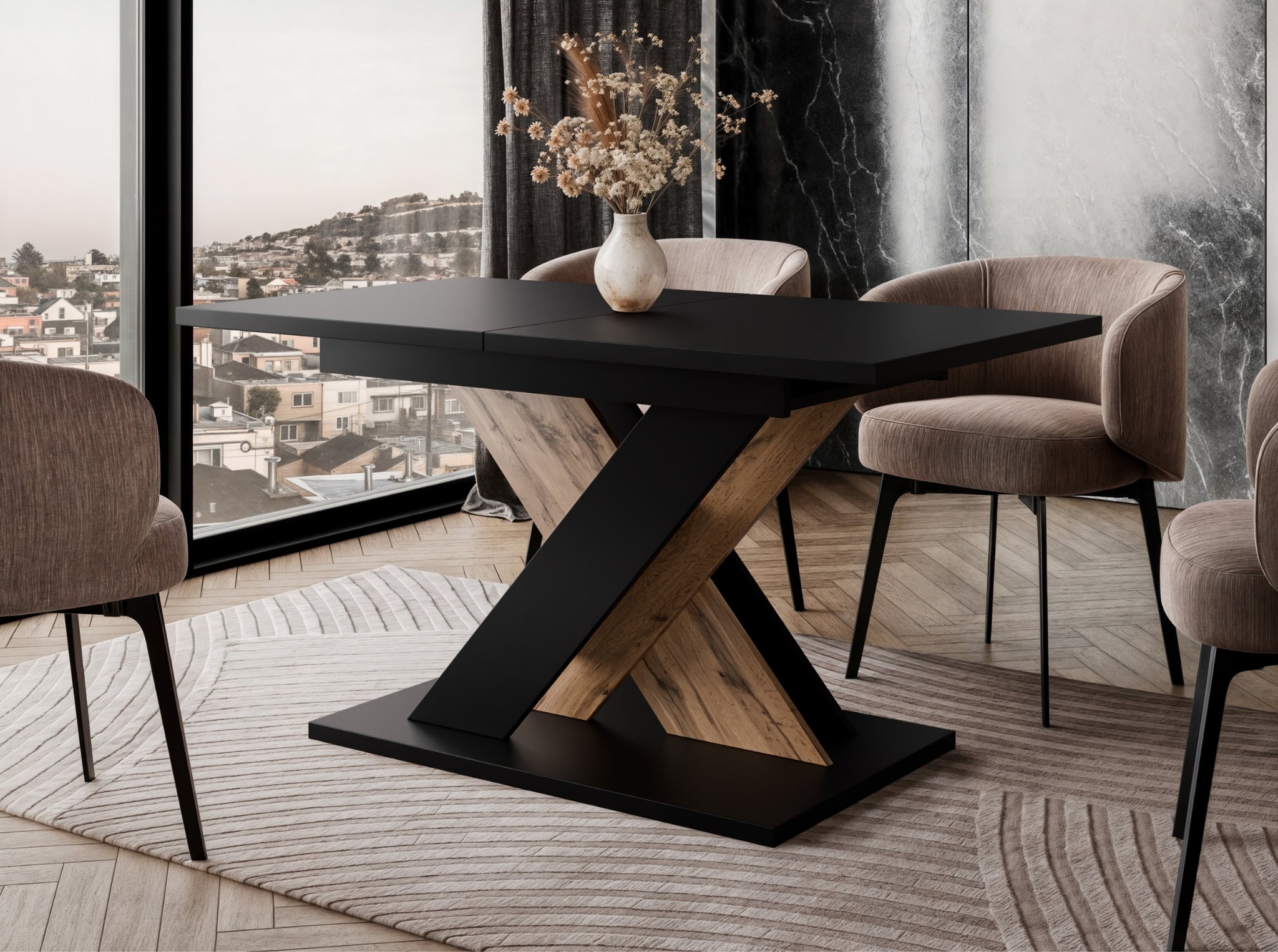 TOXX extending dining table with a black tabletop and wotan oak effect X-shaped base placed in a modern dining room setting, upholstered dining chairs arranged around the table on a rug.