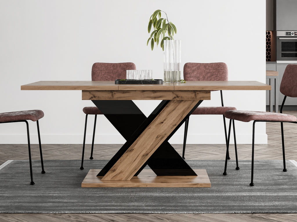 Space-saving extending dining table TOXX with wotan oak effect rectangular tabletop and black gloss X-shaped base, compact design extending from 120 to 160 cm, suitable for modern interiors and smaller dining rooms.
