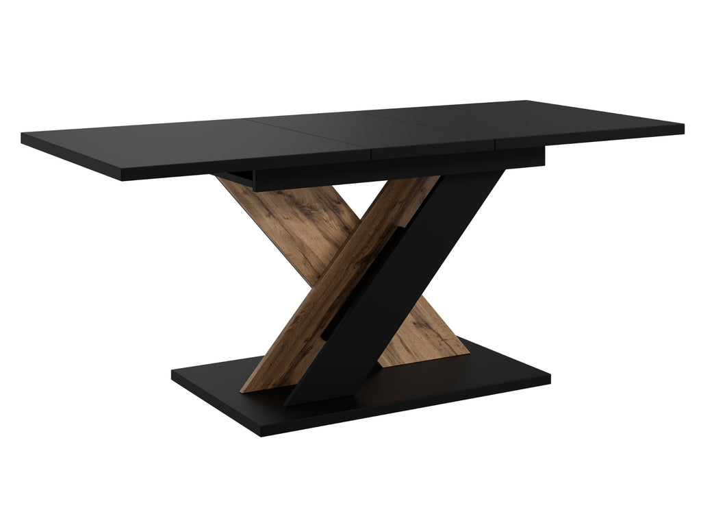 Contemporary dining table TOXX with a matte black tabletop and decorative wotan oak effect base in a distinctive X-shaped design, compact extending table suitable for modern dining rooms and kitchens.