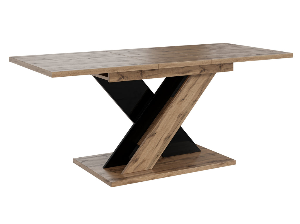 Contemporary dining table TOXX with a natural wotan oak effect tabletop and sturdy black gloss base in a distinctive X-shaped design, compact extending table suitable for modern dining rooms and kitchens.