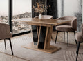 Muss extending dining table with a wotan effect finish placed in a modern dining room setting, black gloss pedestal base, upholstered dining chairs arranged around the table on a decorative rug.