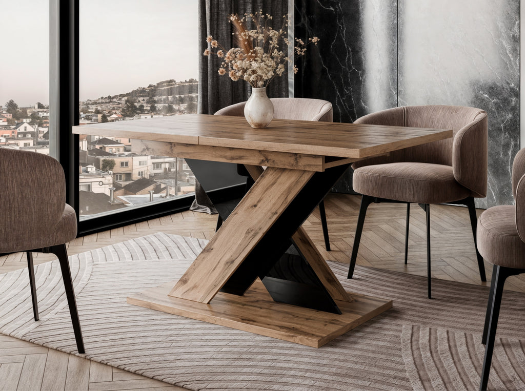 TOXX extending dining table with a wotan oak effect finish placed in a modern dining room setting, black gloss X-shaped pedestal base, upholstered dining chairs arranged around the table on a rug.